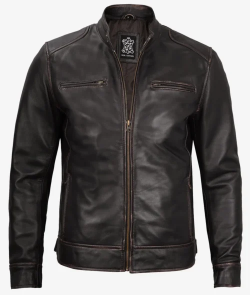 A dark brown leather jacket with a front zipper, two vertical zippered chest pockets, and a collarless design. It conveys a sleek and modern style.