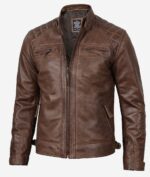 Brown leather jacket with quilted shoulder panels, zip-up front, and four pockets. The rugged design conveys a classic and stylish appearance.