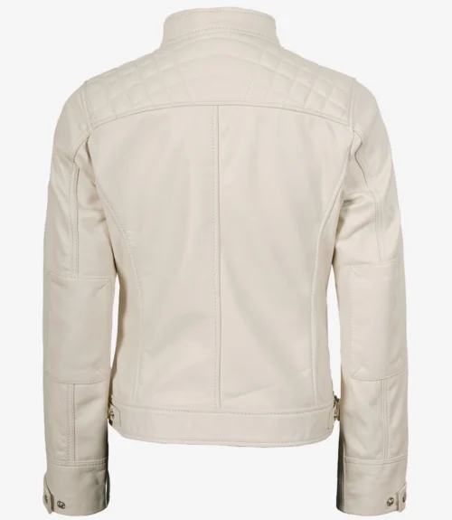 A cream-colored jacket with quilted shoulder details is shown from the back. It features buttoned cuffs, a simple collar, and a straight hemline.