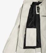 White leather jacket partially open, revealing a black interior lining and a label. The design features a zippered chest pocket and an inner pocket.