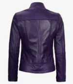 A deep purple leather jacket viewed from the back, featuring a fitted design with vertical seam lines. The fabric appears smooth and glossy.
