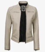 Cream leather jacket with a stand-up collar and open front. Features two zip pockets on the chest and smooth stitching, giving a sleek, modern look.