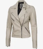 Beige leather biker jacket with a sleek design, featuring multiple zippered pockets and silver snap buttons. The jacket exudes a trendy, edgy vibe.