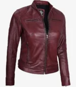 Deep red leather jacket with a sleek, fitted design. Features a front zipper, high collar, and zippered pockets, conveying a stylish, edgy vibe.