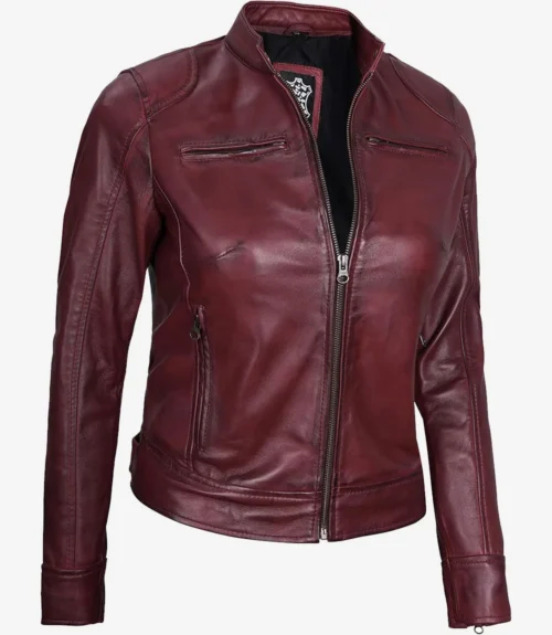 Deep red leather jacket with a sleek, fitted design. Features a front zipper, high collar, and zippered pockets, conveying a stylish, edgy vibe.