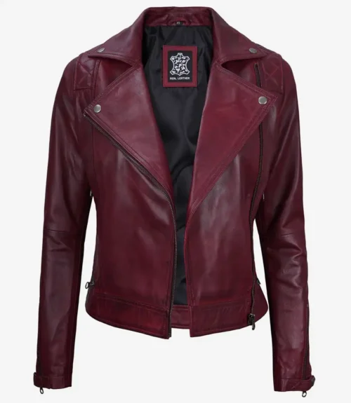 Burgundy leather jacket with a classic biker style, featuring asymmetric zippers, notch lapels, and quilted shoulders. The tone is chic and edgy.