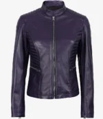 Purple leather jacket with a sleek design, featuring quilted shoulder accents and a front zipper. The style is modern and edgy, conveying sophistication.