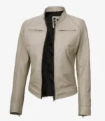 A beige leather jacket with a stand collar, open front, and sleek design. It has zippered chest pockets and a black inner lining, conveying a modern, stylish look.