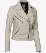 Beige leather jacket with an asymmetrical zipper, black interior, and silver hardware. Features notched lapels and multiple front zip pockets.