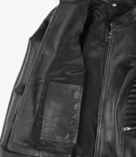 Open black leather jacket showing inner lining and pocket. Visible silver zipper detailing. The jacket conveys a stylish and edgy tone.