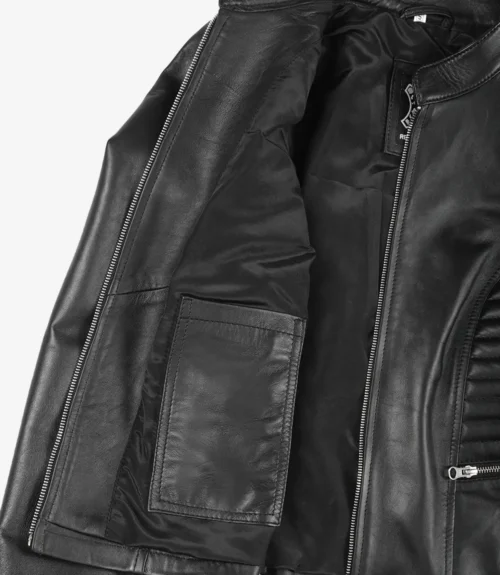 Open black leather jacket showing inner lining and pocket. Visible silver zipper detailing. The jacket conveys a stylish and edgy tone.