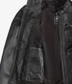 Close-up of an open dark brown leather jacket, revealing a smooth inner lining and a side pocket. The jacket conveys a sleek, stylish appearance.