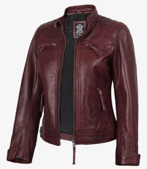 A maroon leather jacket with a quilted design on shoulders and upper back. Features include zippered pockets and front, with a standing collar. Stylish and bold.