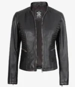 Black leather jacket with zippered front and quilted shoulder accents. Features a high collar and sleek design, exuding a modern and edgy feel.