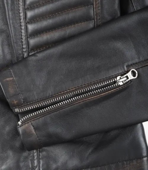 Close-up of a black leather jacket sleeve with a silver zipper. The texture is smooth and slightly worn, conveying a rugged, stylish appeal.