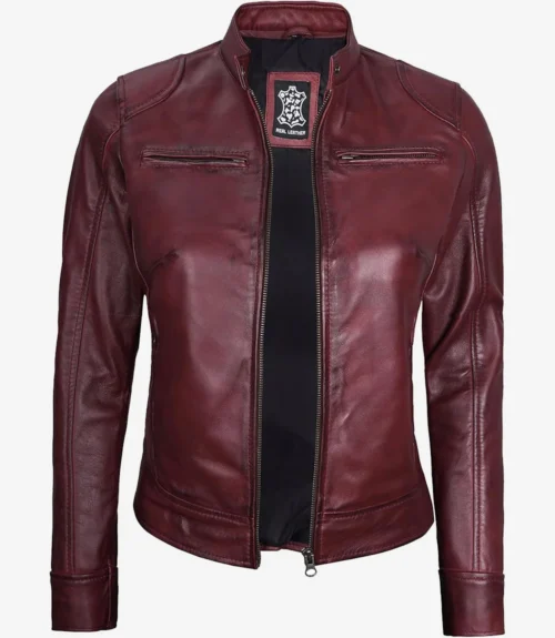 Burgundy women's leather jacket with a front zipper, high collar, and minimalist style. The jacket exudes a sleek and modern feel.