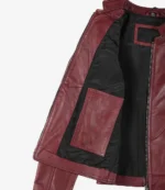 Open maroon leather jacket displaying a black inner lining with a large pocket. The fabric appears sleek and modern, conveying a stylish and bold tone.