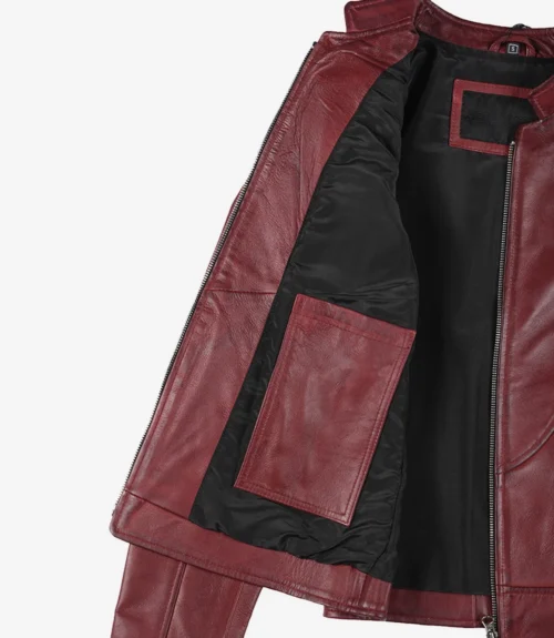 Open maroon leather jacket displaying a black inner lining with a large pocket. The fabric appears sleek and modern, conveying a stylish and bold tone.