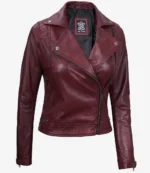 Maroon leather jacket with an asymmetrical zipper, notched collar, and silver snap buttons. It has a stylish, edgy appearance, exuding a bold, modern vibe.