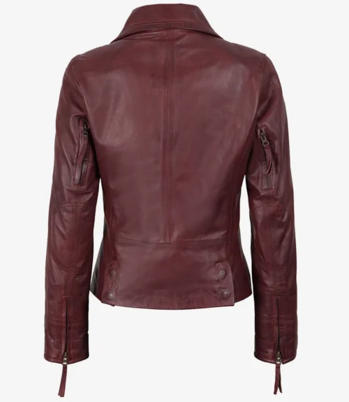 Burgundy leather jacket shown from the back, featuring a sleek design with long sleeves, zippered cuffs, and a fitted waist. The tone is stylish and edgy.