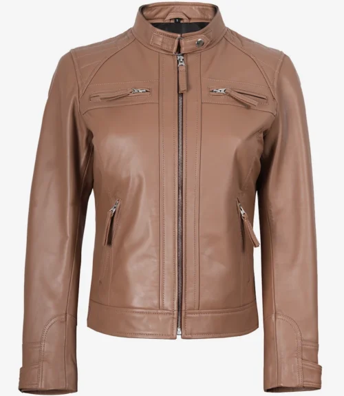 Tan leather jacket with a high collar and silver zip details on the chest and pockets. The sleek design and smooth texture convey a modern, stylish look.