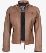 Brown leather jacket with a double zipper, standing collar, and front pockets. The inner lining is black with a label featuring a logo design.
