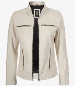 Cream-colored leather jacket with front zipper open, revealing a black inner lining. Features zipper pockets and a logo tag on the back collar.