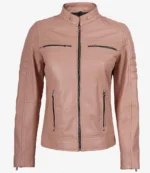 Blush pink leather jacket with a high collar and zippered front. Features zippered pockets and stitched shoulder detailing. Stylish and sleek design.