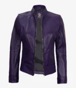A sleek, purple leather jacket with a high collar and central zipper, positioned open to reveal a dark interior. The tag is visible at the neck.