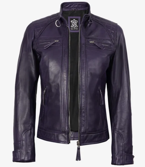 Dark purple leather jacket with a front zipper and zippered pockets. The jacket has a stand collar and quilted detailing on the shoulders, conveying a sleek, edgy style.