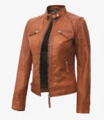 Brown leather jacket with a modern, sleek design, featuring a stand-up collar, front zipper, and multiple zippered pockets, exuding a stylish, edgy vibe.