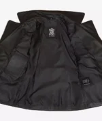 Open black leather jacket, revealing a smooth satin lining. An interior label reads Real Leather, evoking a sleek, modern, and sophisticated vibe.