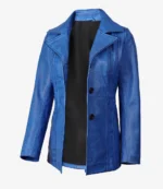 A vibrant blue leather jacket with a black lining is displayed against a plain white background. It features a wide lapel and three black buttons.