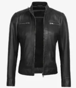 Black leather jacket with a sleek, fitted design on a plain white background. Features zippered chest pockets and a stand-up collar, exuding an edgy, modern vibe.