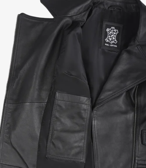 Open black leather jacket laid flat, revealing inner lining with a pocket and a Real Leather label. The texture appears smooth and sleek.