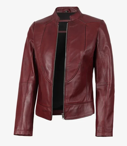 A maroon leather jacket with a sleek, minimalist design. It features a zippered front, stand-up collar, and subtle stitching details on a white background.
