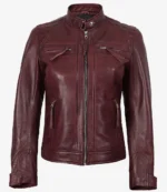 A maroon leather jacket with a front zipper, stand collar, and zipped pockets. It has quilted shoulder details, conveying a stylish, edgy look.