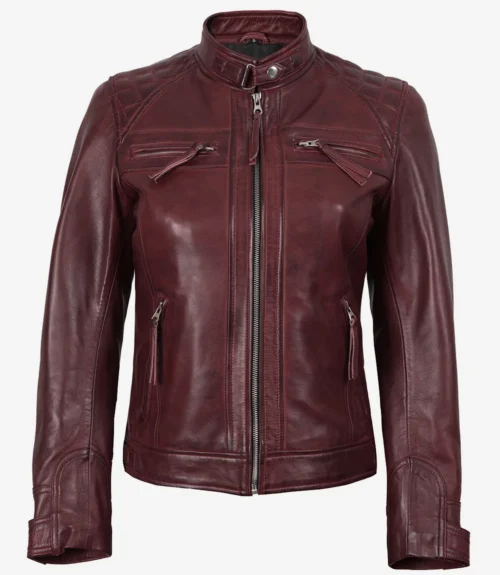 A maroon leather jacket with a front zipper, stand collar, and zipped pockets. It has quilted shoulder details, conveying a stylish, edgy look.