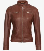 A brown leather jacket with a sleek design is displayed. It features a high collar, front zipper, and two chest zip pockets, exuding a classic, stylish vibe.