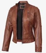 Brown leather biker jacket with a sleek design and quilted shoulders. Features multiple zippered pockets and a front zipper, projecting a stylish, edgy vibe.