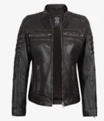 A black leather jacket with a stand collar, zipper pockets, and quilted stitching on the shoulders. It exudes a sleek, edgy vibe.