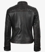 Black leather jacket with quilted shoulder details and a sleek, fitted design. The jacket has adjustable buckles at the waist and buttoned cuffs.