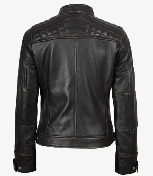 Black leather jacket with quilted shoulder details and a sleek, fitted design. The jacket has adjustable buckles at the waist and buttoned cuffs.