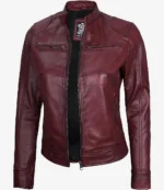 Burgundy leather jacket with a sleek design, featuring zippered pockets and a stand collar. The jacket exudes a stylish and edgy vibe.