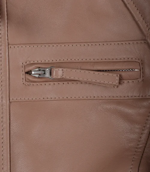 Close-up of a tan leather jacket showcasing a horizontal zippered pocket. The texture appears smooth and polished, conveying a sleek, stylish feel.