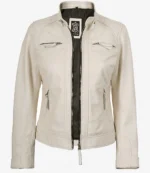 Cream-colored leather jacket with a high collar and zipper closure. Quilted shoulder detail and four zipped pockets add a stylish touch.