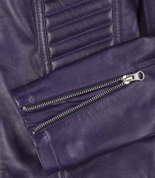Close-up of a purple leather jacket, showcasing its texture and detailing. The image highlights a silver zipper on the sleeve, conveying a stylish, edgy tone.