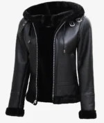 Black leather jacket with a fur-lined hood, accented by silver zippers and buckles. The style is sleek and modern, conveying a bold, edgy tone.
