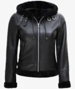 Black leather jacket with a front zipper, featuring a hood and fur lining. The jacket has metal buckles and a sleek, stylish design.