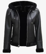 Black leather jacket with a fur-lined hood and cuffs, featuring a front zipper and metal accents. The design conveys a sleek, modern look.